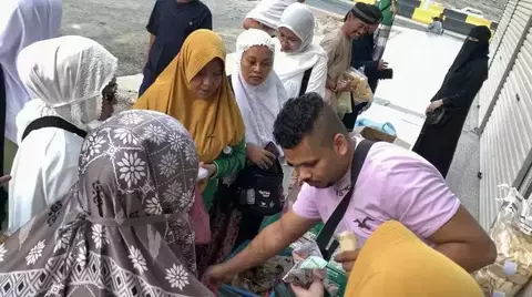 Rasad Ahmad pada Sabtu pagi, 3 Juni 2023 sibuk menggelar lapak dagangan makanannya.