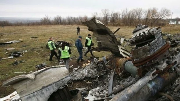 Penyelidik Belanda dan anggota Kementerian Darurat bekerja di lokasi jatuhnya pesawat Malaysia Airlines MH17 di dekat desa Hrabove, Donetsk, Ukraina timur, pada Maret 2014.