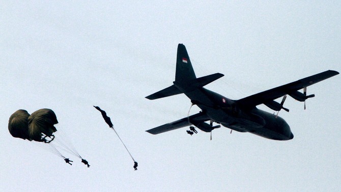 Sejumlah penerjun keluar dari pesawat hercules saat latihan gladi bersih upacara peringatan HUT TNI yang ke 67 di Bandara Halim Perdana Kusuma, Jakarta. FOTO: Ruht Semiono/ SUARA PEMBARUAN