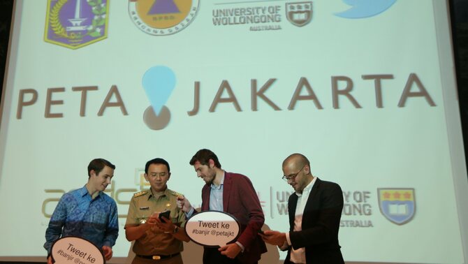 Gubernur DKI Jakarta Basuki T Purnama (kedua kiri) menunjukan tweet pertamanya menggunakan aplikasi PetaJakarta.org kepada Director of Academic Partnership Twitter Mark Gillis (kiri), Direktur Proyek Tomas Holderness (kedua kanan) dan Direktur Proyek Etienne Turpin (kanan) pada peluncurannya di Balai Kota, Jakarta, Selasa (2/12).  