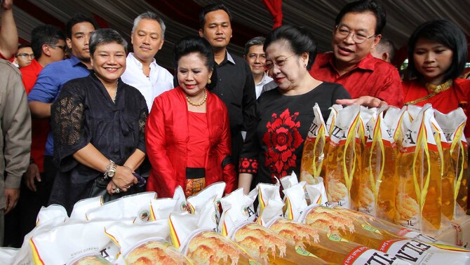 Presiden RI ke-5 Megawati Soekarno Putri (ketiga kanan) bersama Managing Director Sinar Mas G. Sulistiyanto (kedua kanan) memberikan bantuan sembako dan minyak goreng murah kepada warga kurang mampu di Lenteng Agung, Jakarta, Senin (22/12).