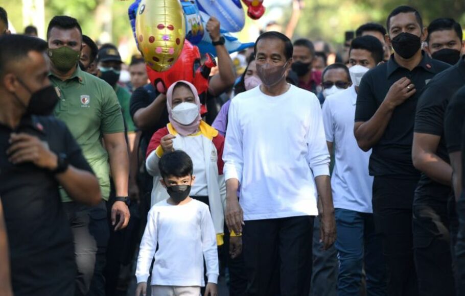 Presiden Joko Widodo (Jokowi) dan Ibu Negara Iriana Joko Widodo berjalan santai bersama cucunya Jan Ethes di sepanjang Jalan Slamet Riyadi, Solo, Jawa Tengah, Minggu, 7 Agustus 2022.  