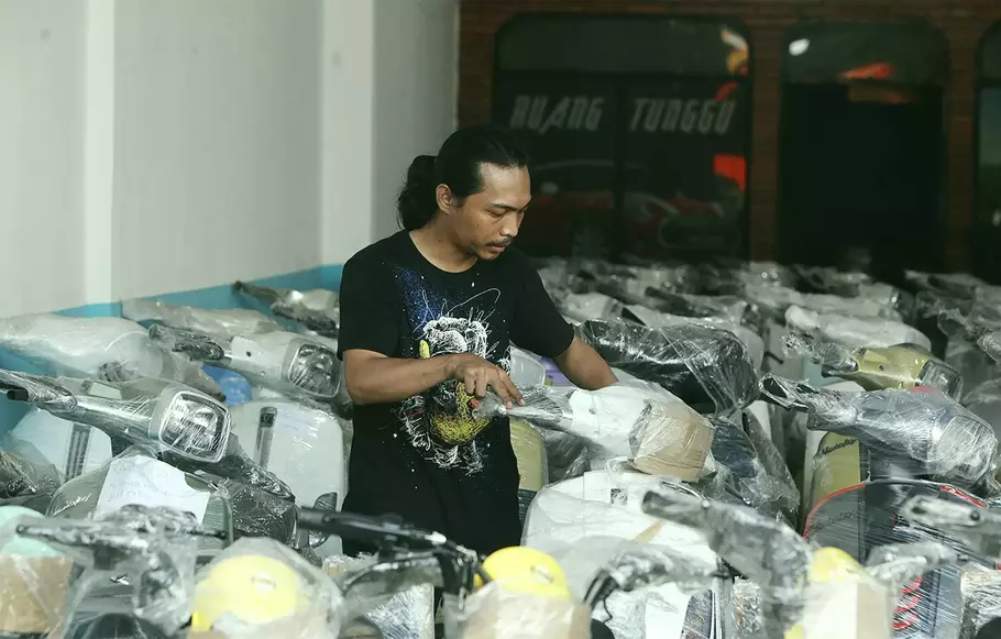 Pekerja merapikan barisan motor listrik yang dijual di salah satu toko motor listrik di kawasan Kampung Melayu, Jakarta Timur, Kamis, 31 Agustus 2023. - (BeritaSatu Photo/Joanito De Saojoao)