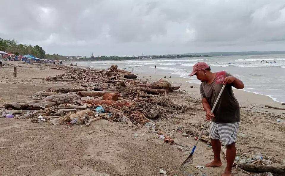 Petugas kebersihan sedang membersihkan sampah di kawasan Pantai Kuta, Kabupaten Badung, Jumat, 17 Februari 2023.