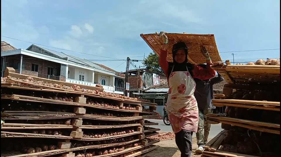 Pekerja tengah menjemur bawang merah di kompleks Pasar Legi Parakan, Temanggung, Kamis, 30 Maret 2023.