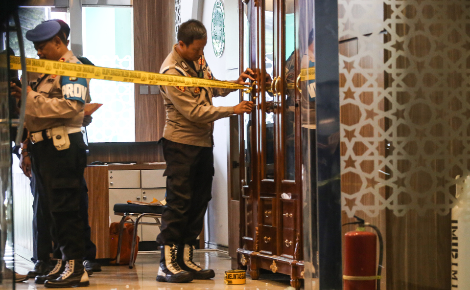 Polisi memasang garis polisi di tempat kejadian perkara (TKP) dugaan penembakan di Kantor Majelis Ulama Indonesia (MUI) Pusat, Jakarta, Selasa, 2 Mei 2023.