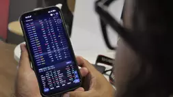 Investor memantau pergerakan saham melalui smartphone. (Investor Daily/David Gita Roza)