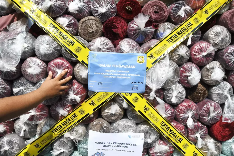 Petugas memeriksa bukti kain gulungan impor ilegal di Tempat Penimbunan Pabean (TPP) Bea dan Cukai, Cikarang, Kabupaten Bekasi, Jawa Barat, belum lama ini. (ANTARA FOTO/Fakhri Hermansyah/YU)