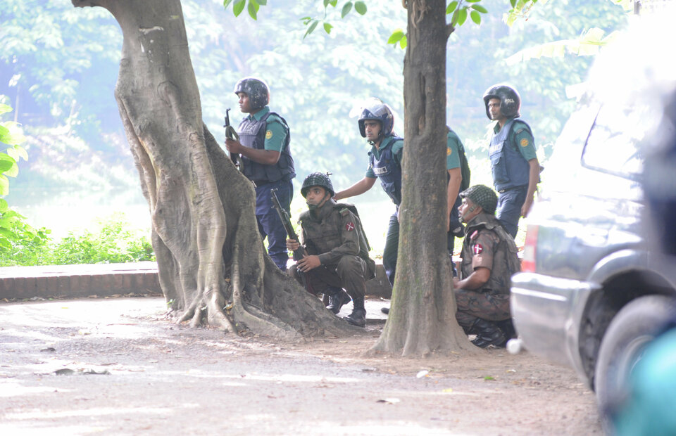Islamist militants shouting "Allahu Akbar" attacked an upscale cafe in the Bangladeshi capital, killing 20 foreigners inside, before police stormed the building on Saturday and rescued 13 hostages, officials said. Army soldiers take their positions near the Holey Artisan restaurant after Islamist militants attacked the upscale cafe in Dhaka, Bangladesh, July 2, 2016. (Handout Photo/Mahmud Hossain Opu)