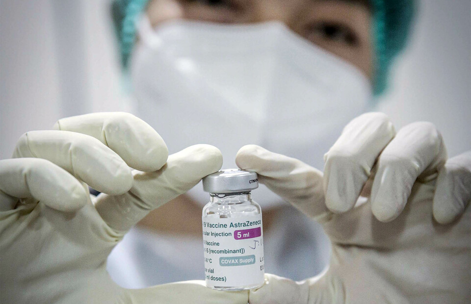A medical worker shows a bottle of AstraZeneca Covid-19 vaccine during a mass immunization event in West Jakarta on May 21, 2021. (Antara Photo)