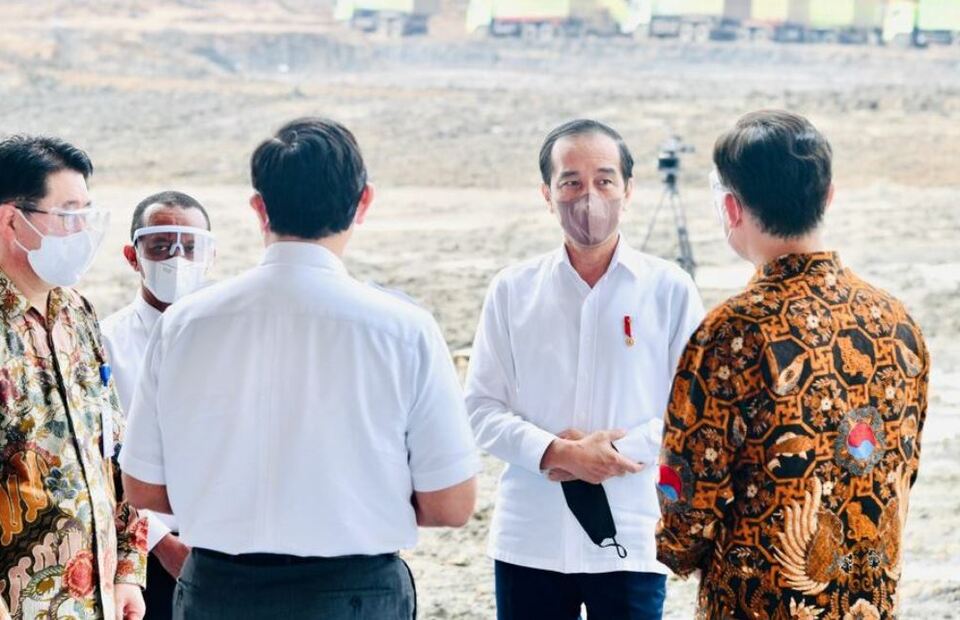 President Joko "Jokowi" Widodo, center, converses with several people on the sidelines of HKML Indonesia