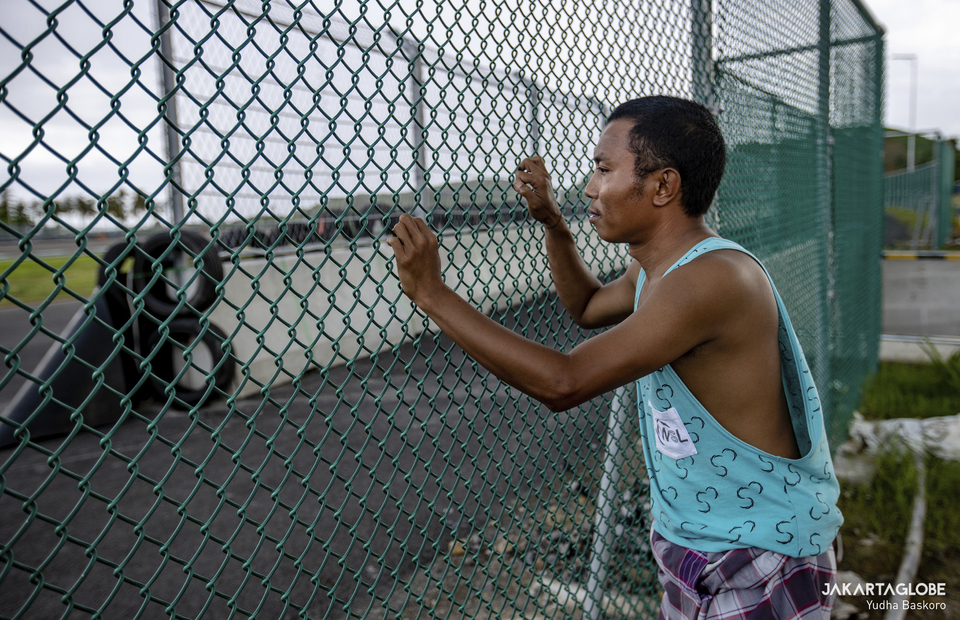 Imran stands by a guardrail at Bunut Hamlet, in the center of Mandalika Circuit, Central Lombok, West Nusa Tenggara on November 22, 2021. (JG Photo/Yudha Baskoro)