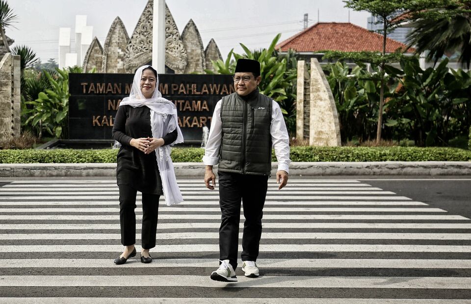 House of Representatives Speaker Puan Maharani, left, and National Awakening Party (PKB) Chairman Muhaimin Iskandar walk on a pedestrian crossing near the Kalibata Heroes Cemetery in South Jakarta on September 25, 2022. (Joanito De Saojoao)