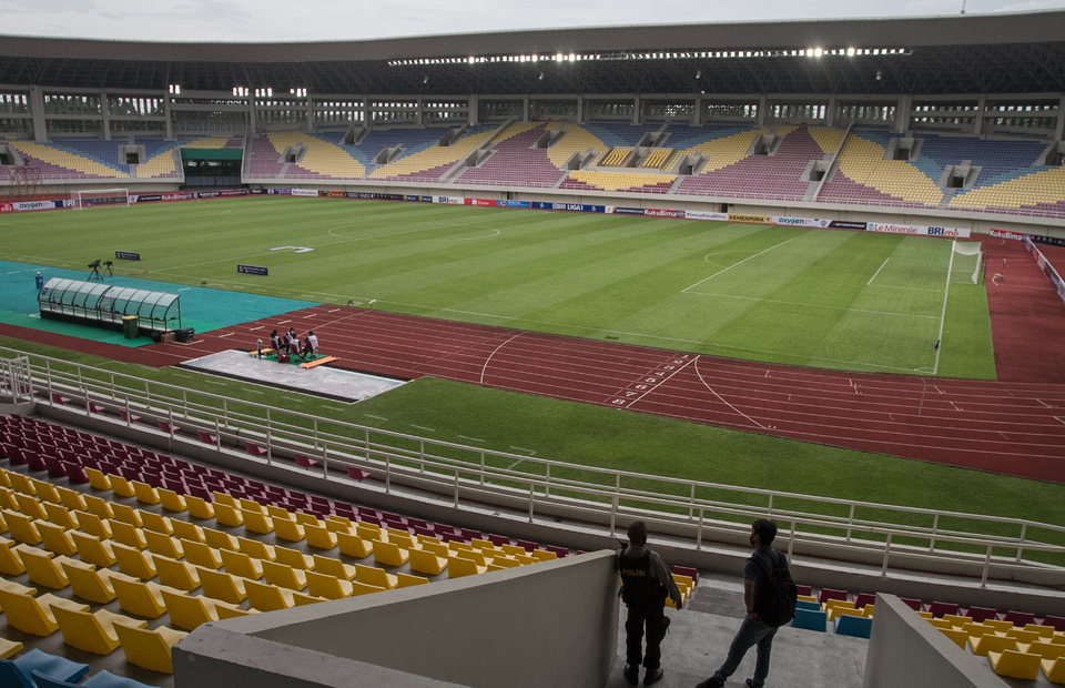 Two men stand on the seating rows of Manahan Football Stadium on December 5, 2022. The stadium in the Central Java town of Solo is proposed to host matches of the U20 World Cup starting on May 20, 2023. (Antara photo)