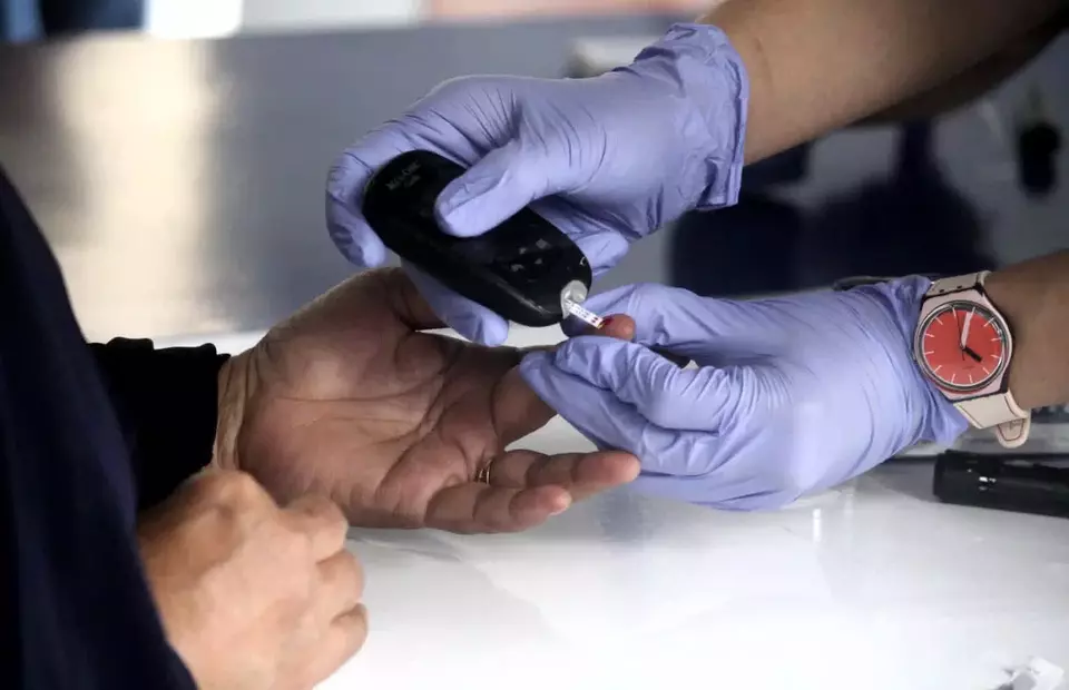 A health worker checks a train passenger's blood sugar level at a diabetes prevention campaign at Tanah Abang Station in Jakarta on Nov. 14, 2021. (B Universe Photo/Mohammad Defrizal)