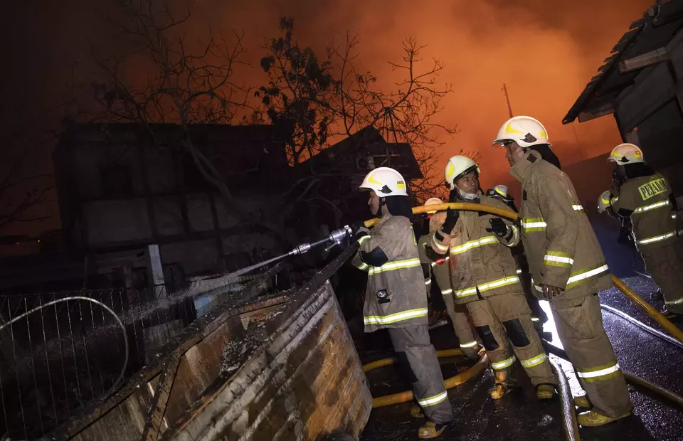 Firefighters attempt to put out the fire that destroys homes near Pertamina oil depot in Koja, North Jakarta, on March 3, 2023. (Antara Photo)