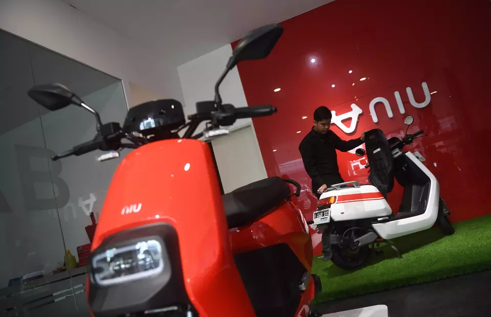 A man inspects the electric two-wheeler at a dealer in Jakarta on March 6, 2023. (Antara Photo/Akbar Nugroho Gumay)