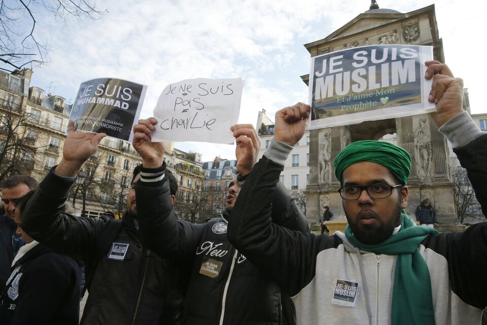 French Muslim youths hold placards which read, ‘I am Muslim. I love my Prophet’, right, and ‘I am Muhammad. I belong to the Muslim community and I am anti-terrorist’ during a demonstration in central Paris on Jan. 18, 2015. (Reuters Photo/Pascal Rossignol)