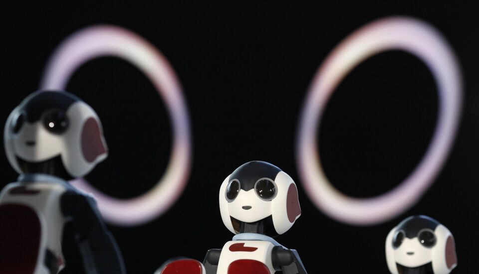 A hundred humanoid communication robots called Robi sit before a dance performance dance during a promotional event called 100 Robi, for the Weekly Robi Magazine, in Tokyo January 20, 2015. (Reuters Photo/Yuya Shino)