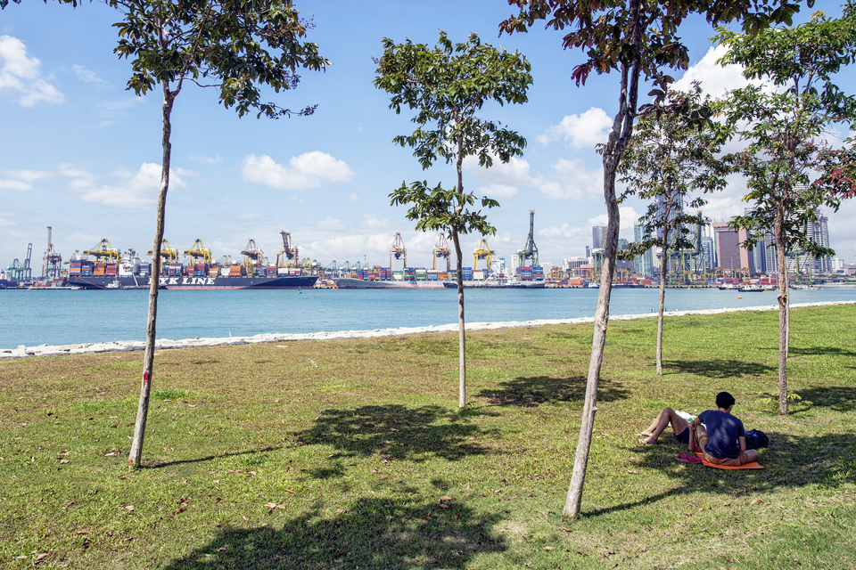 People rest as container ships sitting docked at the Tanjong Pagar Container Terminal, operated by PSA International, in Singapore, on Jan. 14, 2015. (Bloomberg Photo/Bryan van der Beek)