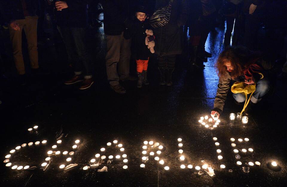 People light candles forming the name Charlie during  a gathering in Strasbourg, eastern France. (AFP Photo/Patrick Hertzog)