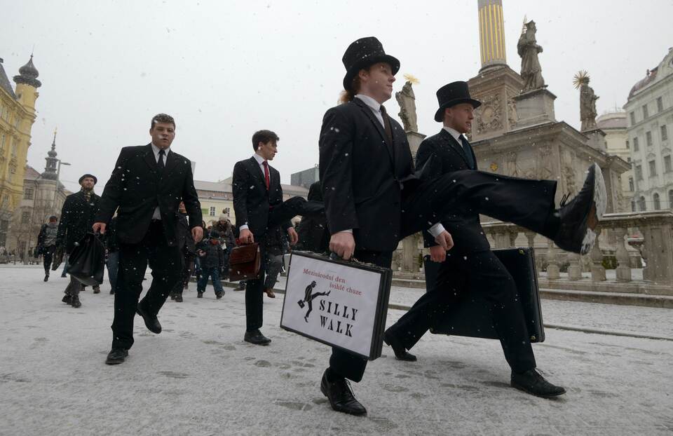 Fans of the British comedy group Monty Python perform their skills during the International Silly Walk Day on Jan. 7, 2015, in Brno, Czech Republic. (AFP Photo/Michal Cizek)