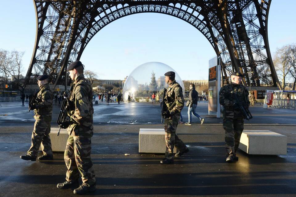French soldiers patrol in front of the Eiffel Tower on Jan. 8, 2015 in Paris. (AFP Photo/Bertrand Guay)