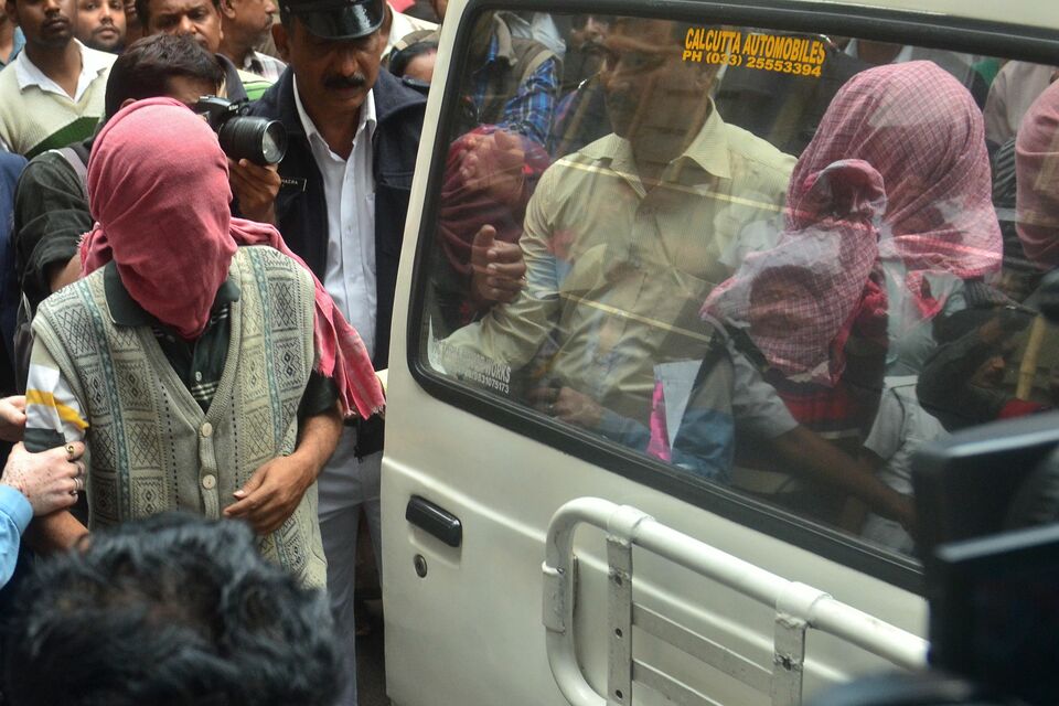 Indian police officials escort suspects in the alleged gang-rape and extortion of a Japanese tourist held as a sex slave (AFP Photo/Stringer)