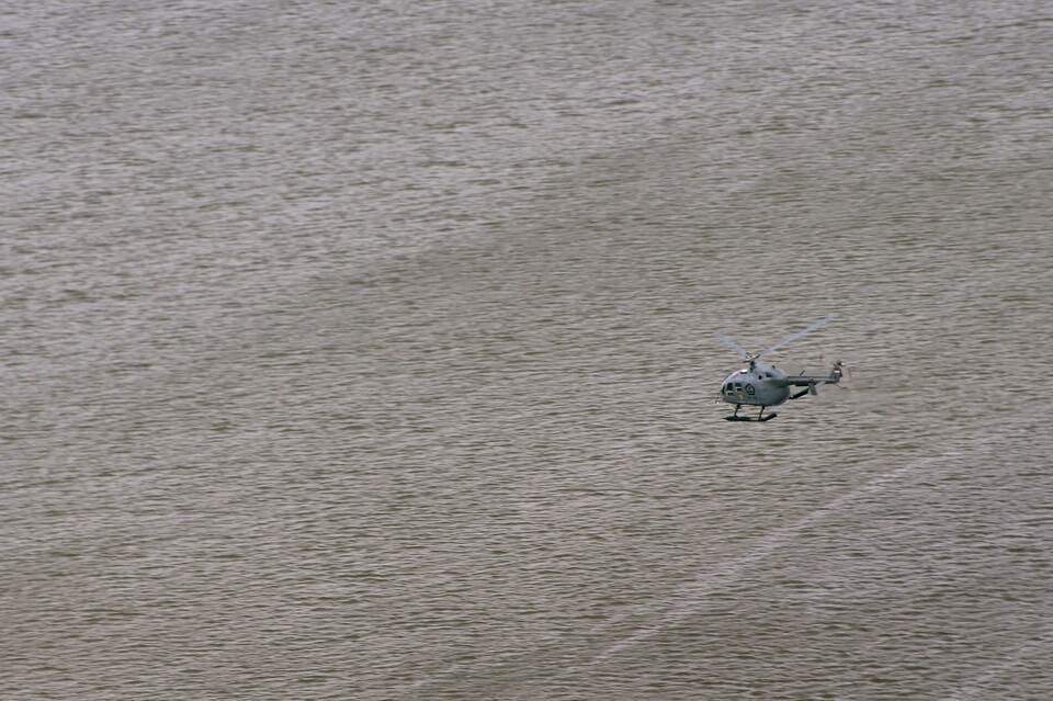 An Indonesian helicopter searches for victims and debris during recovery operations on Jan. 1, 2015 for Indonesia AirAsia flight QZ8501 that crashed in the Java Sea. (AFP Photo/Adek Berry)