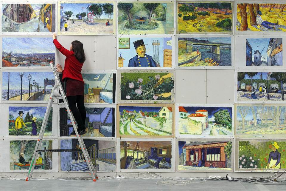 Joanna Maleszyk hangs up recreations of Vincent van Gogh paintings at a film studio in the northern Polish city of Gdansk on December 5, 2014. She is one of dozens of Polish artists working on "Loving Vincent", the world