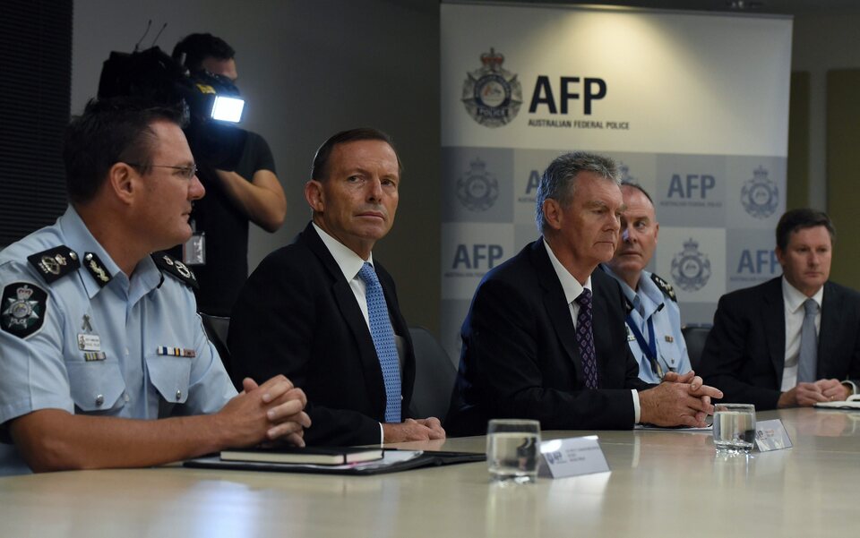 Australian Prime Minister Tony Abbott, center left, and Australian Security Intelligence Organisation (ASIO) Director General of Security Duncan Lewis, center right, attend a counterterrorism briefing at the Operations Coordination Centre of the Australian Federal Police (AFP) headquarters in Canberra, Australia, on Feb. 12, 2015. (EPA Photo/Lukas Coch Australia and New Zealand Out)