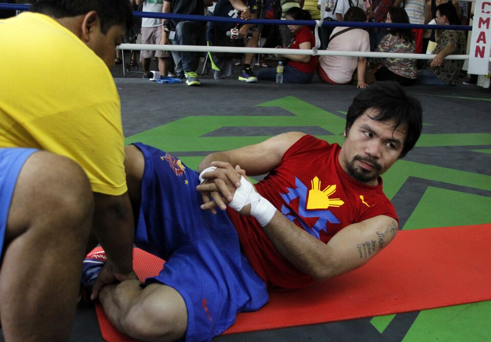 Philippine boxing icon Manny Pacquaio stretches prior to a training session at a gym in General Santos City in  Mindanao on Feb. 23, 2015. (AFP Photo)