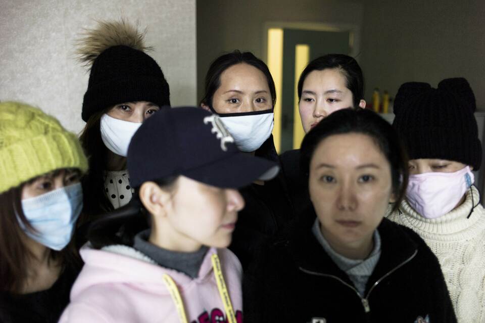 women who say they have been left disfigured by shoddy procedures in South Korea, wait in a clinic room in Beijing. (AFP Photo/Fred Dufour)