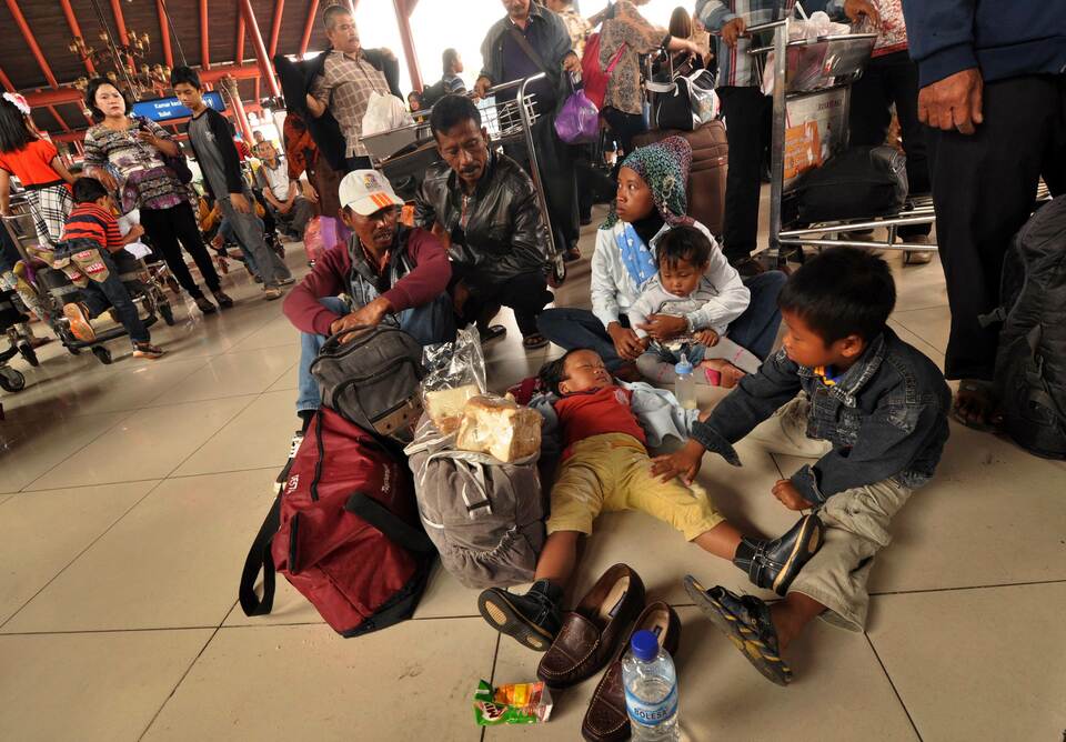 Stranded passengers of Indonesia's biggest low-cost airline Lion Air wait at the domestic airport terminal of Soekarno-Hatta International Airport outside Jakarta on Feb. 20, 2015. Lion Air was left scrambling after a second day of major delays saw thousands of angry passengers barricading gates and staging noisy protest inside the country's main airport terminal. (AFP Photo/Bima Sakti)