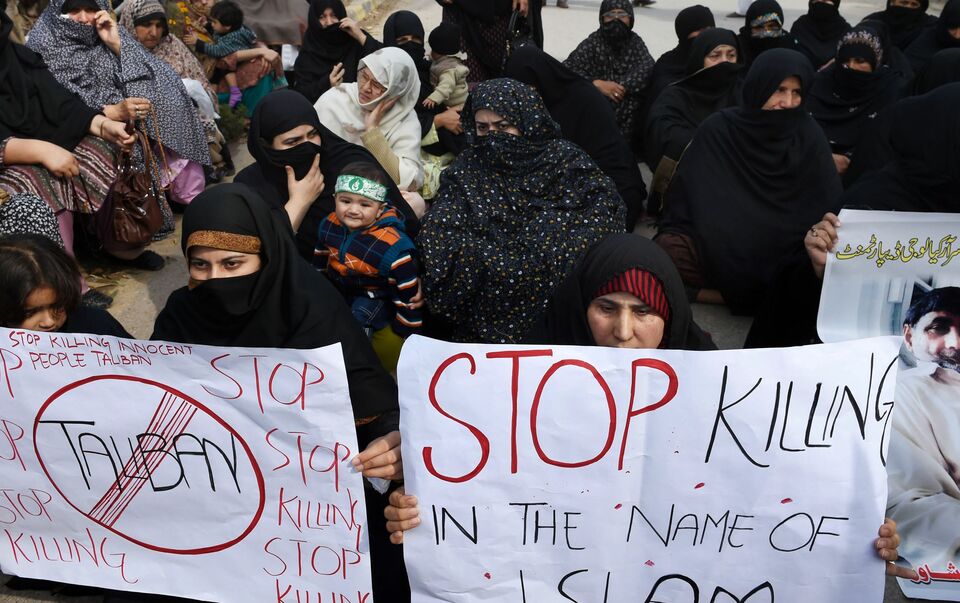 Pakistani Shiite Muslim demonstrators hold posters during a protest against a suicide bomb attack on a Shiite mosque in Peshawar, on Feb. 20, 2015. (AFP Photo/A. Majeed)