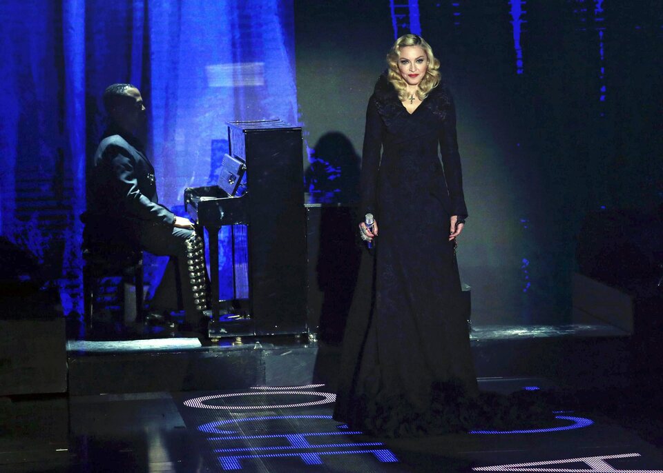 A handout picture released by Endemol Press Office on 08 March 2015 shows US singer Madonna (right) performing at the Italian television channel Rai3 talk show 'Che tempo che fa' (lit.: What Time ago), in Milan, Italy, 01 March 2015. (EPA Photo/Matteo Bazzi)