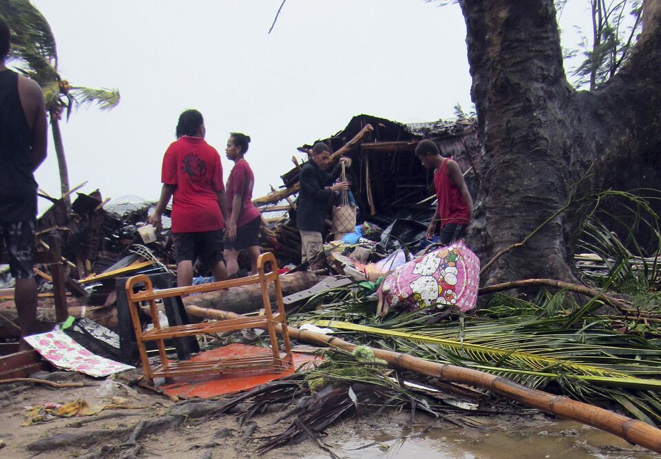 Local residents look through the remains of a small shelter in Port Vila, the capital city of the Pacific island nation of Vanuatu March 14, 2015. (Reuters Photo/UNICEF Pacific)