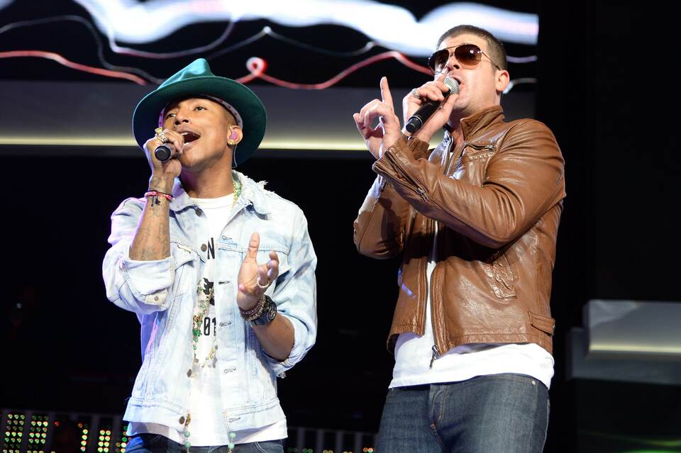 This file photo taken on June 6, 2014 shows recording artists Pharrell Williams (left) and Robin Thicke performing during the Walmart 2014 annual shareholdersmeeting at Bud Walton Arena at the University of Arkansas in Fayetteville, Arkansas. A US jury on March 10, 2015 ordered pop stars Robin Thicke and Pharrell Williams to pay over $7 million in damages to the family of Marvin Gaye, ruling the pair copied his music in writing their 2013 mega-hit "Blurred Lines." (AFP Photo/Jamie McCarthy)