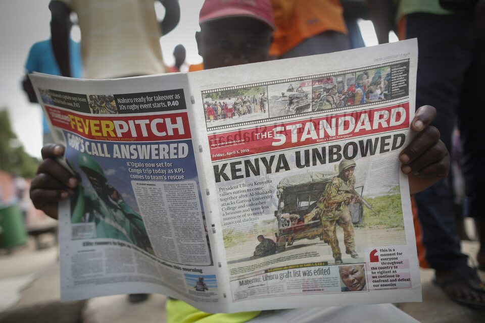 A local resident reads a newspaper featuring an article on an attack on Garissa University College in Garissa town, located near the border with Somalia, some 370 kilometers northeast of the capital Nairobi, Kenya, on April 3, 2015, the day after gunmen attacked the university. (EPA Photo/Dai Kurokawa)