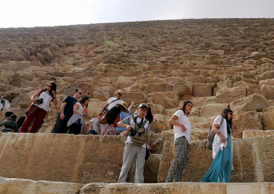 Tourists visit the famous pyramids in Giza, Egypt, on April 4, 2015.(EPA Photo/Khaled Elfiqi)