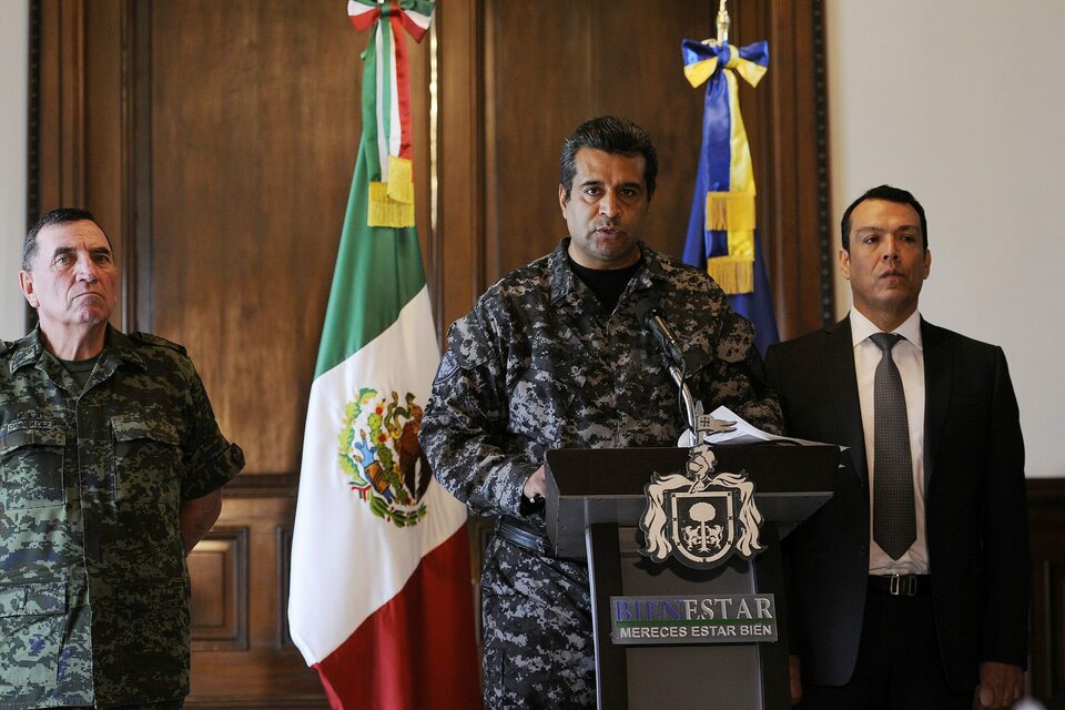A handout photo released by the government of Jalisco state shows security commissioner of Jalisco Alejandro Solorio, center, speaking during a press conference in Guadalajara, Mexico, on April 7, 2015. Solorio confirmed that 15 members of police were killed by an unknown organized crime group after an ambush on a road near Soyatan village. (EPA Photo/Government of Jalisco/Handout)
