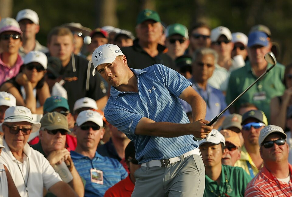 Jordan Spieth chips onto the 18th green from the gallery during third round play of the Masters golf tournament at the Augusta National Golf Course in Augusta, Georgia, US on April 11, 2015. (Reuters Photo/Brian Snyder)