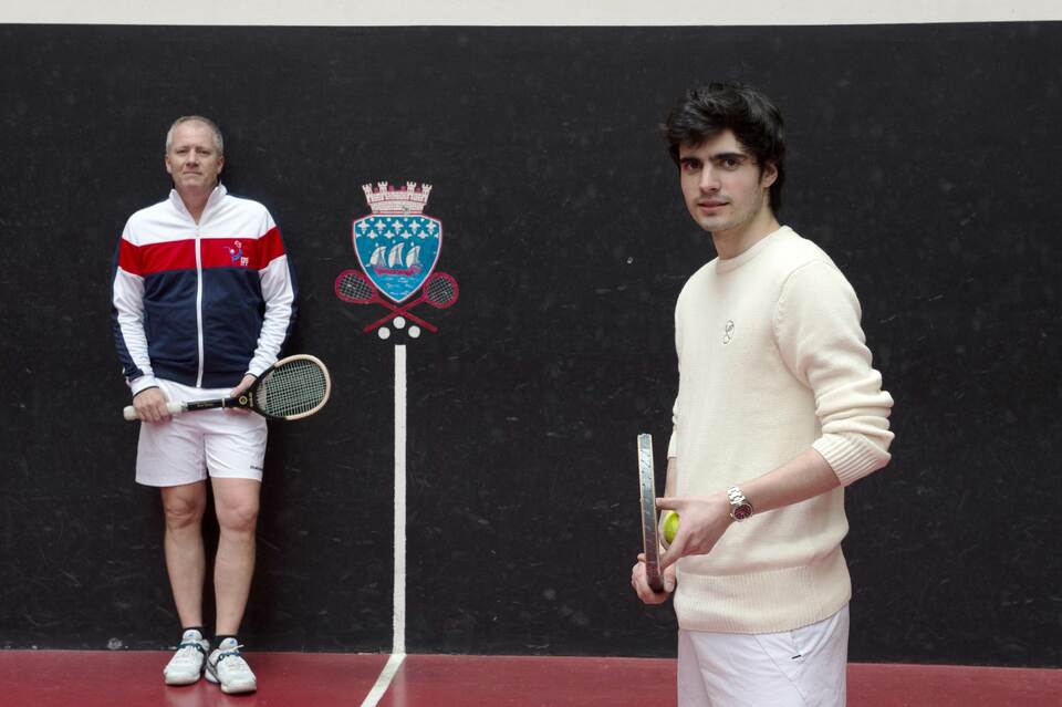 French Jeu de Paume champion Matthieu Sarlangue, right, poses with his coach Tim Batten at the Jeu de Paume (Real Tennis) and Squash club in Paris on March 31, 2015. (AFP Photo/Martin Bureau)