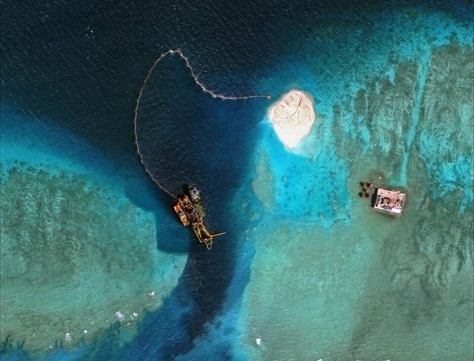 This handout photo taken on Feb.1, 2015 by satellite imagery provider DigitalGlobe and released to AFP on April 11, 2015 by the Asia Maritime Transparency Initiative department at the Center for Strategic and International Studies (CSSI) think tank shows a satellite image of purported dredging work at the southern entrance to Mischief Reef in the Spratly Islands in the disputed South China Sea. (AFP Photo/CSIS Asia Maritime Transparency Initiative/DigitalGlobe)