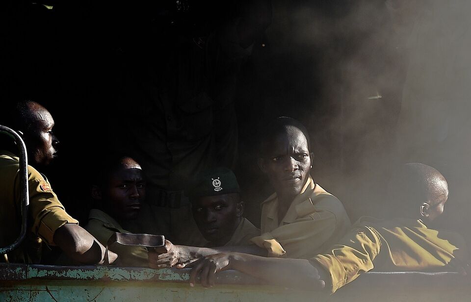 Members of Kenya’s police force look out from the back of a truck as it enters the university campus of the northeastern town of Garissa on April 3, 2015 one day after Somalia’s Al Shabaab Islamist group staged an attack. (AFP Photo/Carl de Souza)