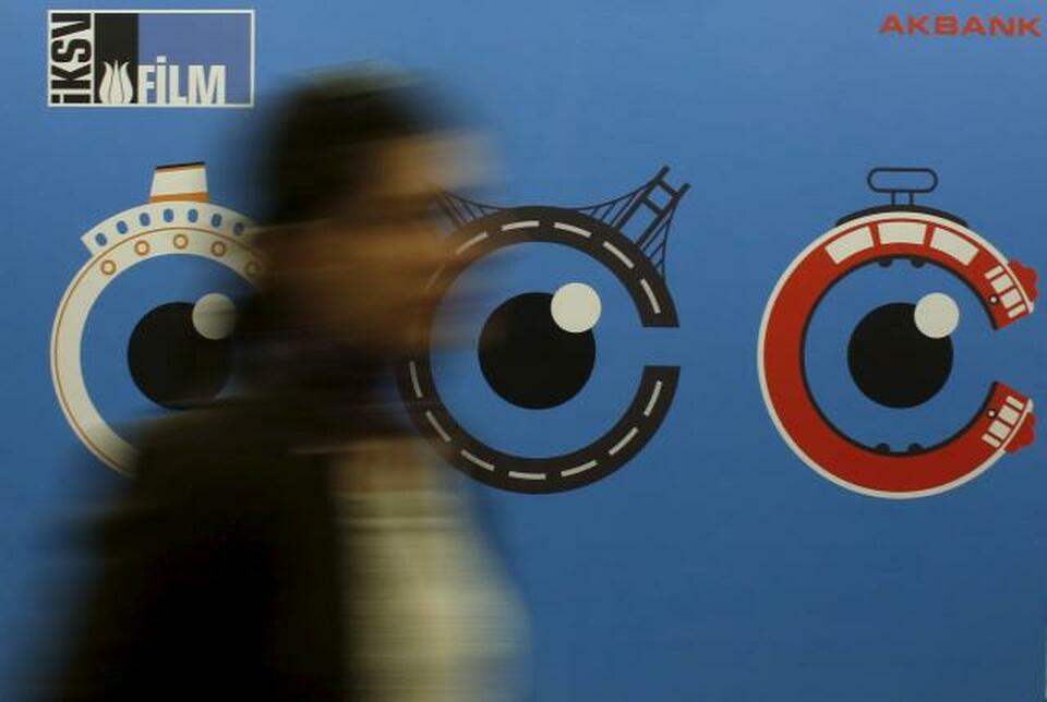 A woman walks past by a banner of Istanbul Film Festival at Atlas movie theatre in Istanbul April 14, 2015. (Reuters Photo/Murad Sezer)