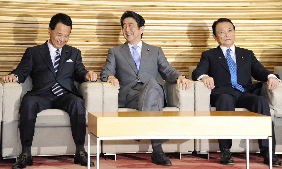 Japanese Prime Minister Shinzo Abe (C) shares a light moment with Economic Revitalization Minister Akira Amari (L) and Finance Minister Taro Aso (R) during a cabinet meeting at his official residence in Tokyo on January 14, 2015. Japan approved the largest-ever defence budget for the next fiscal year, as hawkish Prime Minister Shinzo Abe eyes to strengthen the surveillance of territorial waters in face of the growingly aggressive giant neighbour, China.    AFP PHOTO / JIJI PRESS    JAPAN OUT