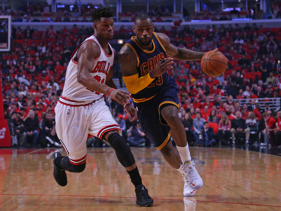Cleveland Cavaliers forward LeBron James (23) dribbles the ball as Chicago Bulls guard Jimmy Butler (21) defends. (Reuters Photo/Dennis Wierzbicki)