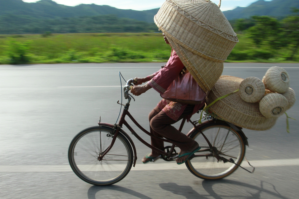 A craftsmen on a bicycle carrying rattan products toward the city center while passing by Jalan Lhoknga, Aceh Besar, Aceh, on May 18, 2015. (Antara Photo/Ampelsa)