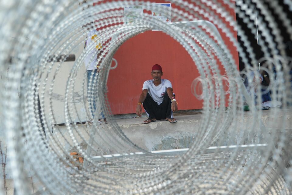 A Bangladeshi boat migrant sits at a shelter in Langsa, Aceh. (AFP Photo/Chaideer Mahyuddin)